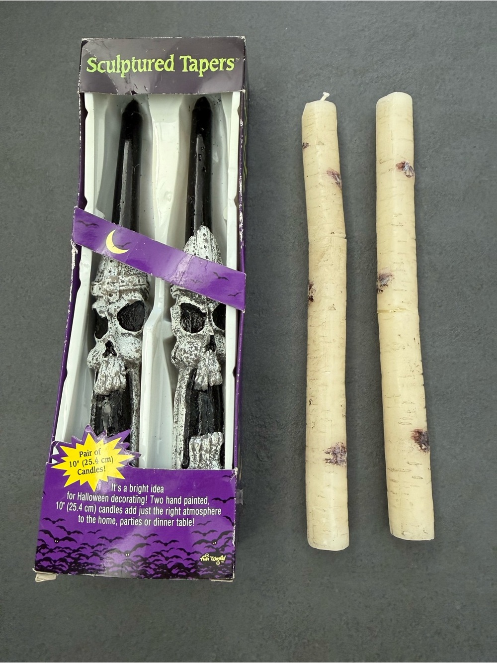 4 Halloween candles. 2 Black Skull and 2 spooky wood grain